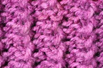 Texture of violet knitted fabric as background, top view
