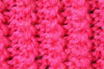Texture of pink knitted fabric as background, top view
