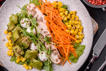 Fresh juicy salad with meat, mozzarella, carrots, lettuce, corn