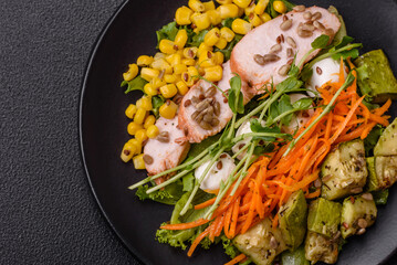 Fresh juicy salad with meat, mozzarella, carrots, lettuce, corn