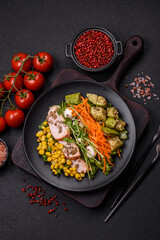 Fresh juicy salad with meat, mozzarella, carrots, lettuce, corn