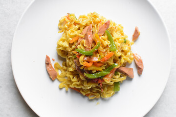 Overhead view of Singaporean noodles on a white plate, top view of Singaporean fusion noodles