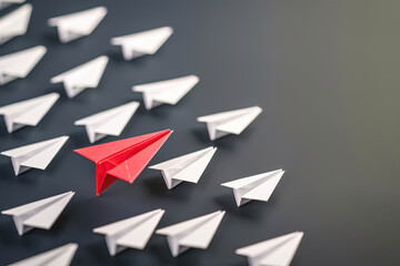 A striking image of a red paper airplane leading a group of white ones, symbolizing leadership and innovation.