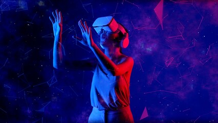 Excited smiling Asian woman looking around through VR metaverse with pointing on blue neon digital universe starry zodiac virtual space fantastic exploration nebula vibrant meta world. Hallucination.