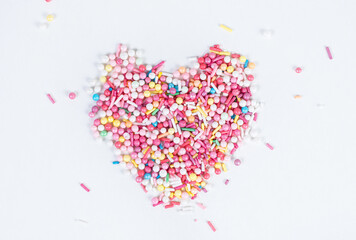 heart shape from colorful sprinkles on white background, valentine's day, romantic love concept