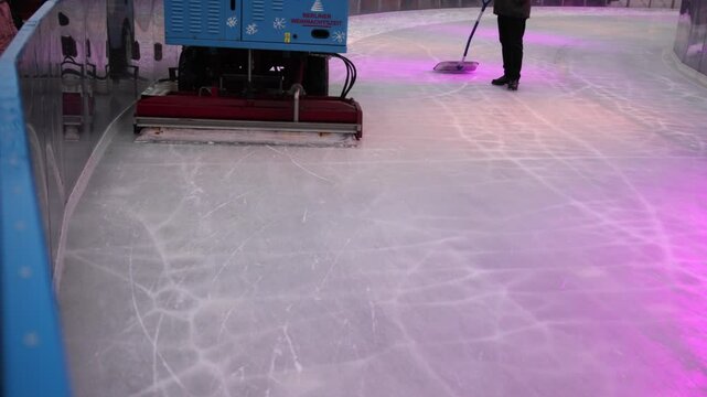Smooth Ice, Wintery Scene, Snow Removal. Rink is brightened by lively lights as ice resurfacer navigates through scattered snow.
