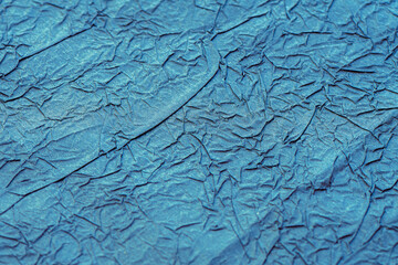 Crumpled matte blue paper. Wrapping paper. Abstrack background, wallpaper. Blue minimalistic...