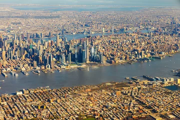 View from airplane window during takeoff over New York with Manhattan's skyscrapers and Hudson River. USA.