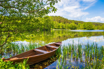 Fishing boat at lake Turtulu near Czarna Hancza river in spring season, Suwalski Landscape Park,...