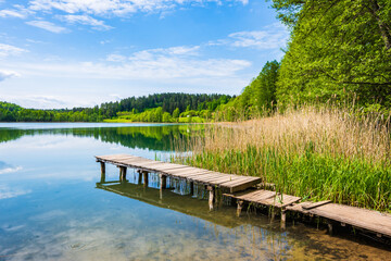 Wooden pier on shore of beautiful Wigry lake, Wigry National Park, Podlasie, Poland