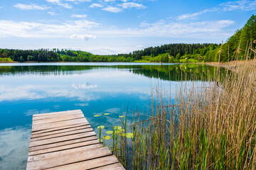 Wooden pier on shore of beautiful Wigry lake, Wigry National Park, Podlasie, Poland