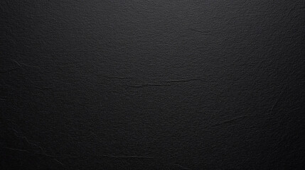 smooth, unblemished sheet of black paper, highlighting its uniform texture and matte finish, ideal for backgrounds, design elements, or concepts of simplicity and minimalism
