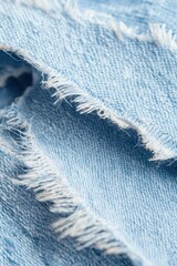 A macro shot revealing the threads and rugged texture of a torn denim fabric.