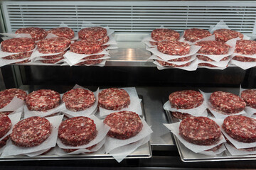 Stacked Hamburger patties in a Butcher Shop