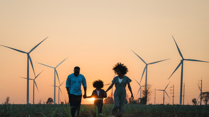 family looking windmills. African American family in the community with wind generators turbines, Wind turbines are alternative electricity sources, sustainable resources and Renewable energy.
