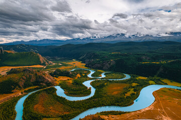 Beautiful autumn landscape with blue meanders winding river with yellow trees Altai mountains, Siberia, Russia. Aerial top view photo