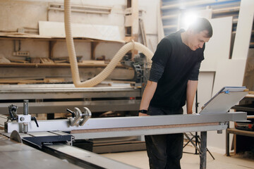 Carpentry workshop industry, craftsman hand marking wooden kitchen furniture