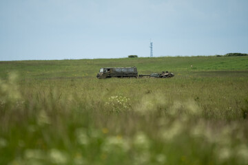 British army bae systems, Puch, Daimler, Pinzgauer High-Mobility All-Terrain 6x6 vehicle towing a 105mm Light Artillery Gun on a military exercise © Martin