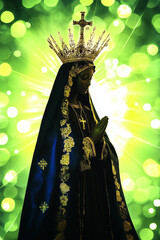 Sacred statue of Our Lady of Aparecida (Nossa Senhora Aparecida), Brazilian patroness. Glowing bokeh background emphasizes faith and devotion. Ideal for Catholic religious concepts with space for text