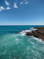 Majestic Rocky Coastline with Turquoise Sea and Blue Sky