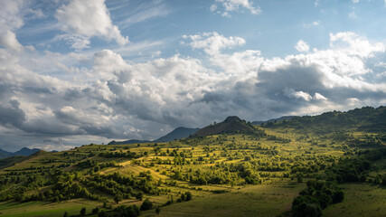 Beautiful hilltops with green forest and warm light.