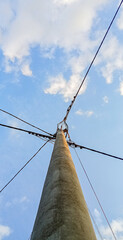 power pole with cables against a blue sky