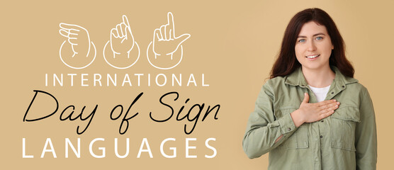 Young deaf mute woman using sign language on color background