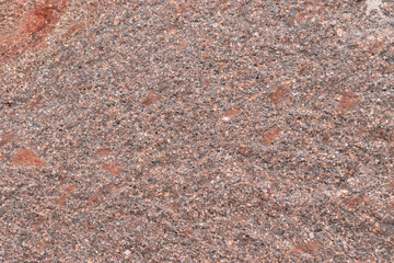 Rough texture of natural stone in shades of orange and brown