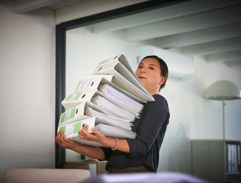 Portrait, carry and businesswoman with heavy paperwork in administration career crisis or workload. Folder, binder and overwhelmed administrator with stack or pile of documents for deadline workplace