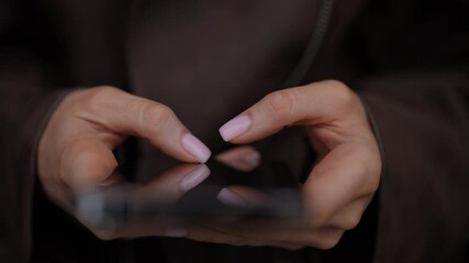 Closeup top view of female hands holding smartphone typing on screen, using mobile applications, swiping social network profile pages, chatting in messenger, web surfing information, shopping online