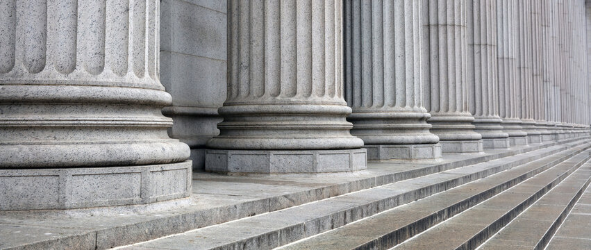 Stone colonnade and stairs detail. Classical pillars row in a building facade