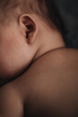 Tiny ear of a newborn baby, children's details aesthetics
