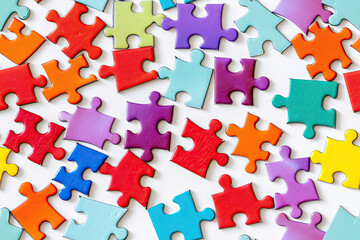 Bright multi-colored puzzles on a white background, top view