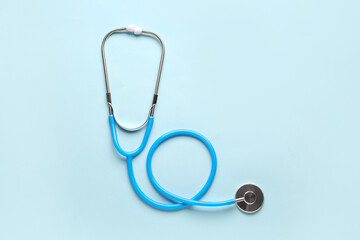 Modern stethoscope on light blue  background