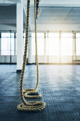 Fototapeta premium Ropes, empty and fitness in gym, training and challenge with wellness, sports and endurance. Health, facility center or exercise with workout, climbing or cardio with competition, active or equipment