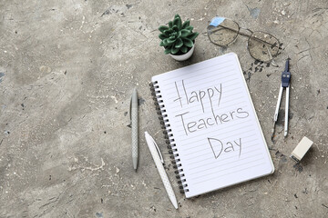 Notebook with text HAPPY TEACHERS DAY, eyeglasses and different stationery on grunge grey background