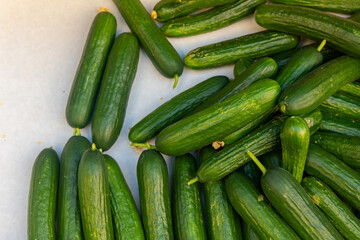 bunch of green cucumbers are piled on top of each other