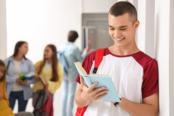 Teenage boy reading book at school