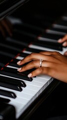 Obraz premium A woman's hand with a ring on her finger playing a piano