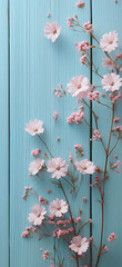 Obraz premium A flat lay of delicate white and pink flowers against a serene blue wooden backdrop creates a dreamy pastel aesthetic.Copy space