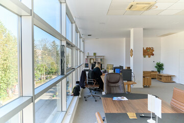 Modern Office Interior with Wooden Furniture, Conference Table, and Computers