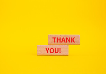 Thank you symbol. Wooden blocks with words Thank you. Beautiful yellow background. Business and Thank you concept. Copy space.