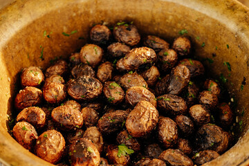 A beautifully presented bowl overflowing with tasty, roasted baby potatoes, artfully garnished with...
