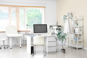 Light interior of doctor's office with modern workplace