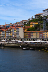 View of Porto city and Douro river and Dom Luis bridge. Porto, Vila Nova de Gaia, Portugal. Cityscape along the river
