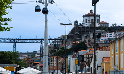  gondolas of the Gaia cable car passing just above typical houses in the Vila Nova de Gaia...