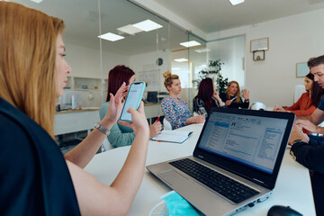 Obraz premium Diverse Business Team Discussing Projects in a Modern Glass Office.