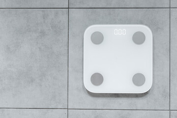 Smart technology concept. White modern electric smart weighing scales with 0 number, top view, copy space