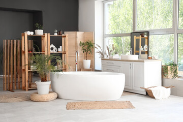Stylish interior of modern bathroom with different houseplants
