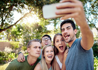Funny face, humor and selfie with group of friends outdoor in nature together for bonding or profile picture. Comedy, joking or social media with smile of men and women in park for photograph